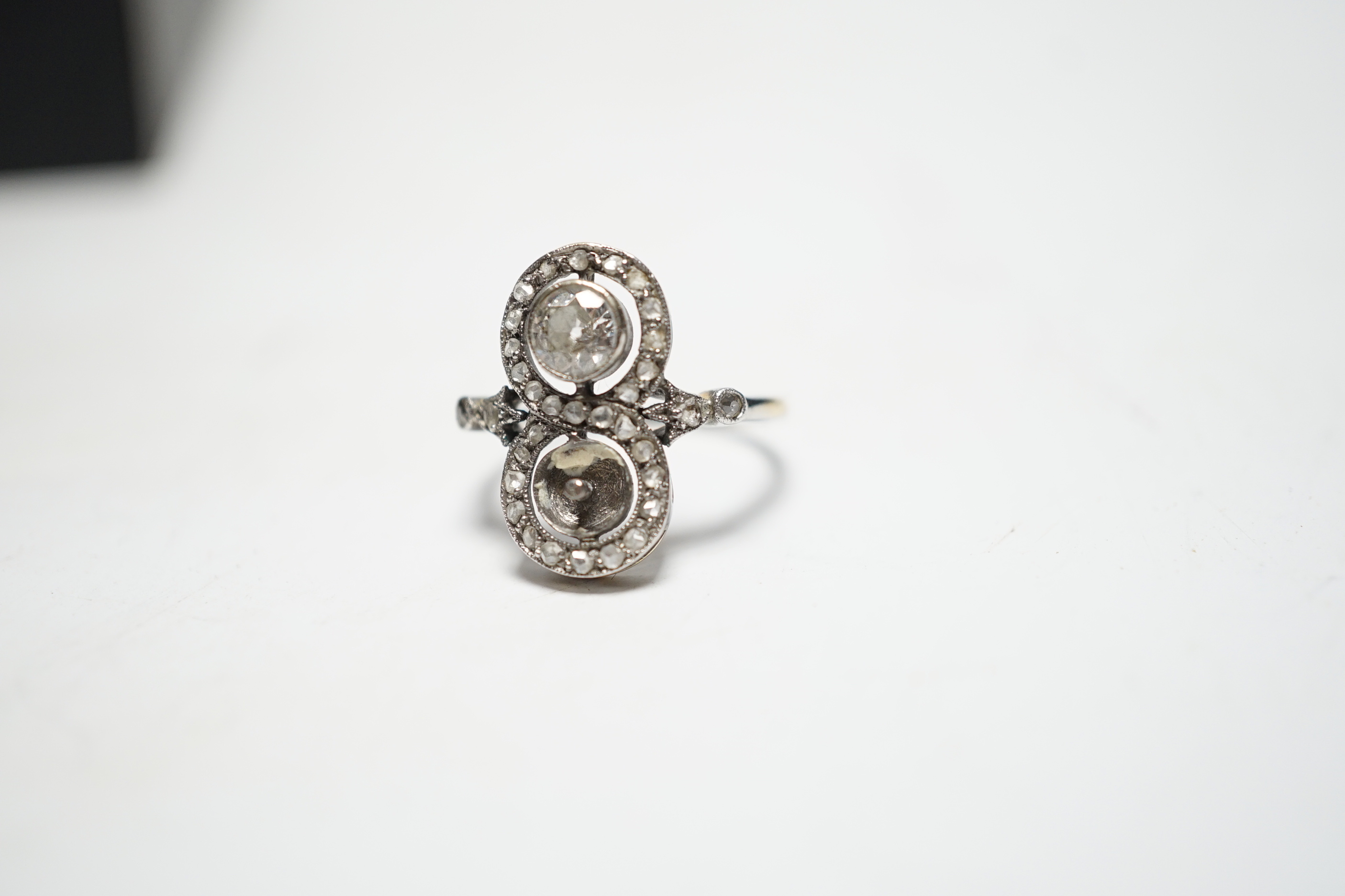 A 1920's white metal, diamond and pearl? set up finger ring, with diamond set borders and diamond set shoulders, (pearl missing), size J, gross weight 2.7 grams.